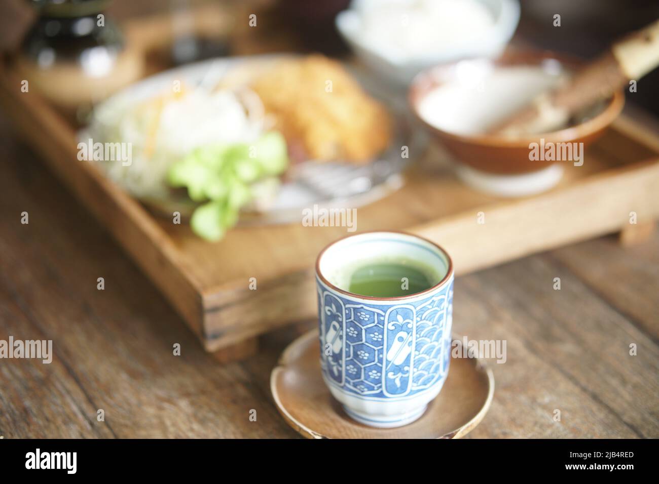 hot matcha green tea in ceramic mug with japanese food set Stock Photo