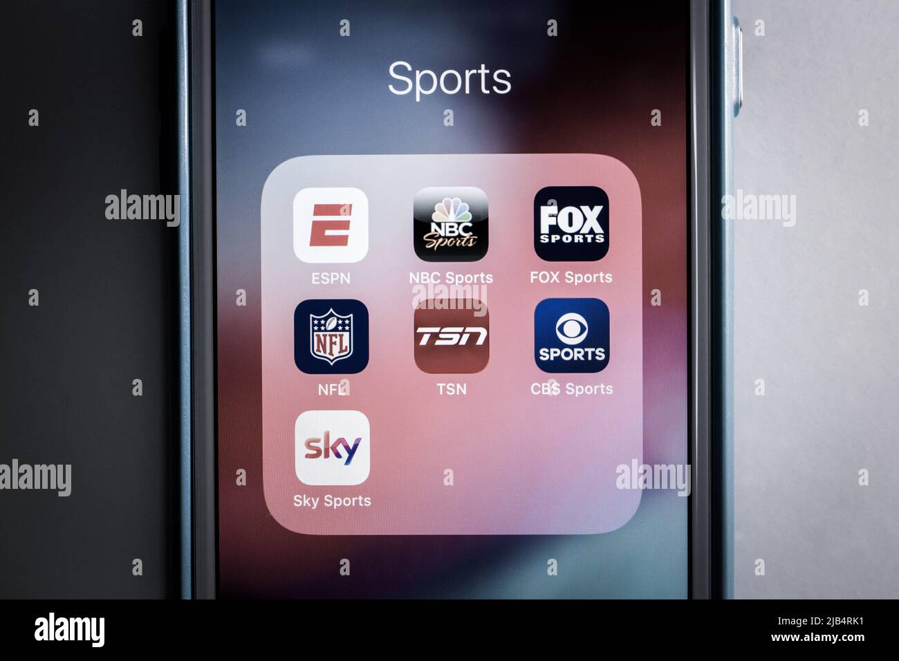Logos of popular sports media / apps in monochrome. ESPN & competitors / alternatives (NBC, FOX, NFL, TSN, CBS and Sky) icons on iPhone. Stock Photo