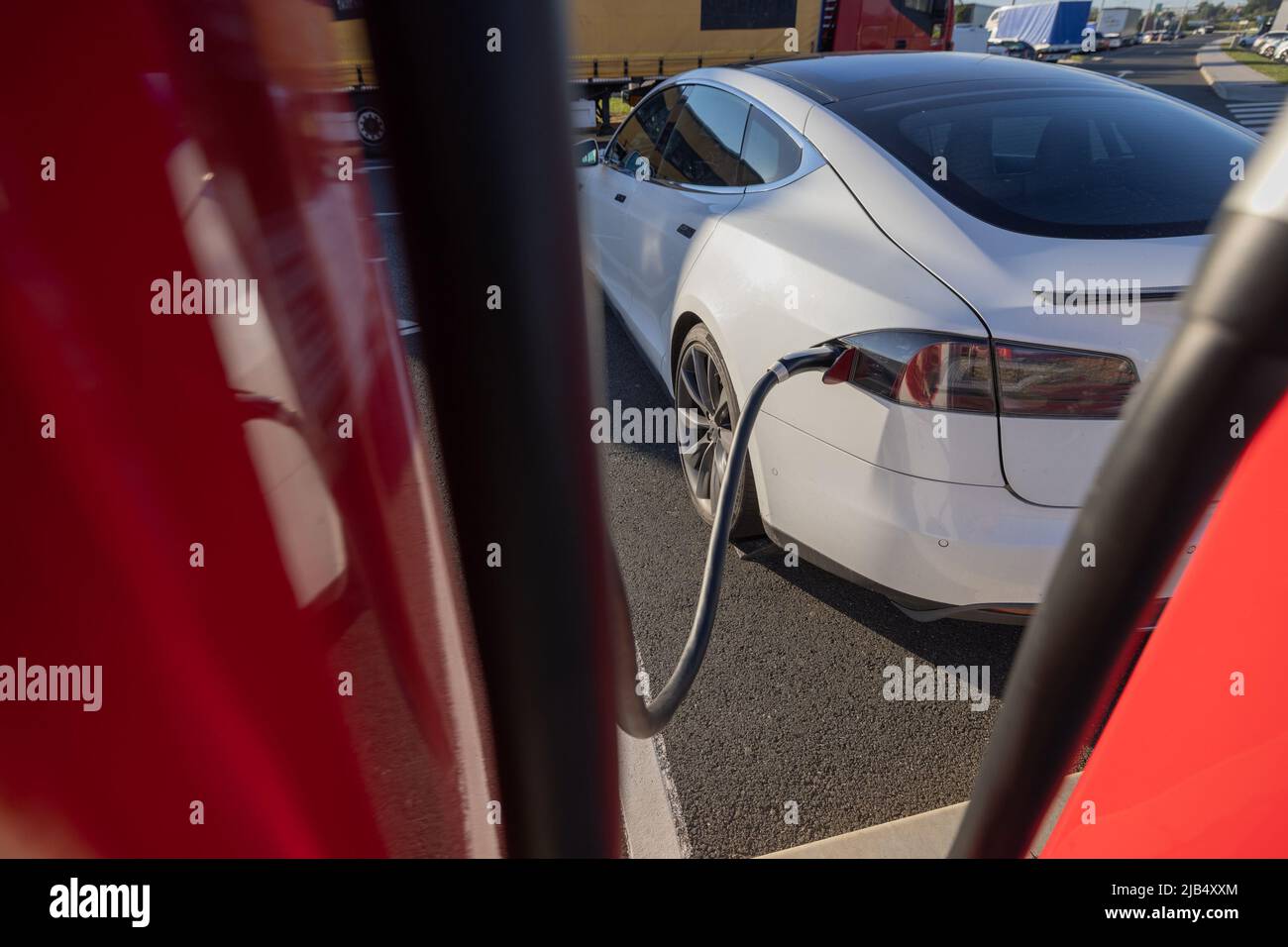 Charging an electric car. Modern electric car being charged on a fast ...