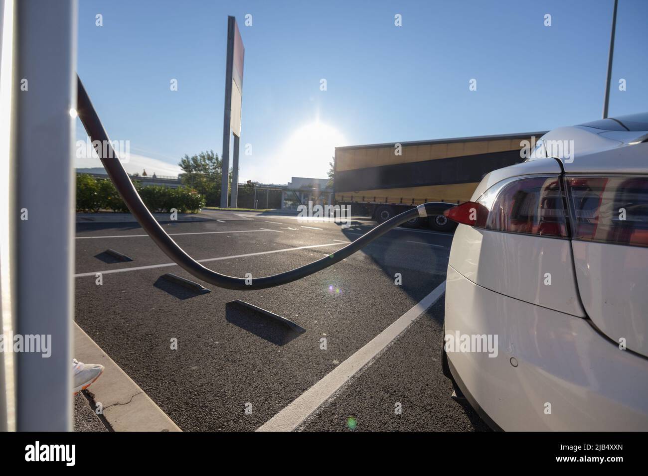 Charging an electric car. Modern electric car being charged on a fast ...