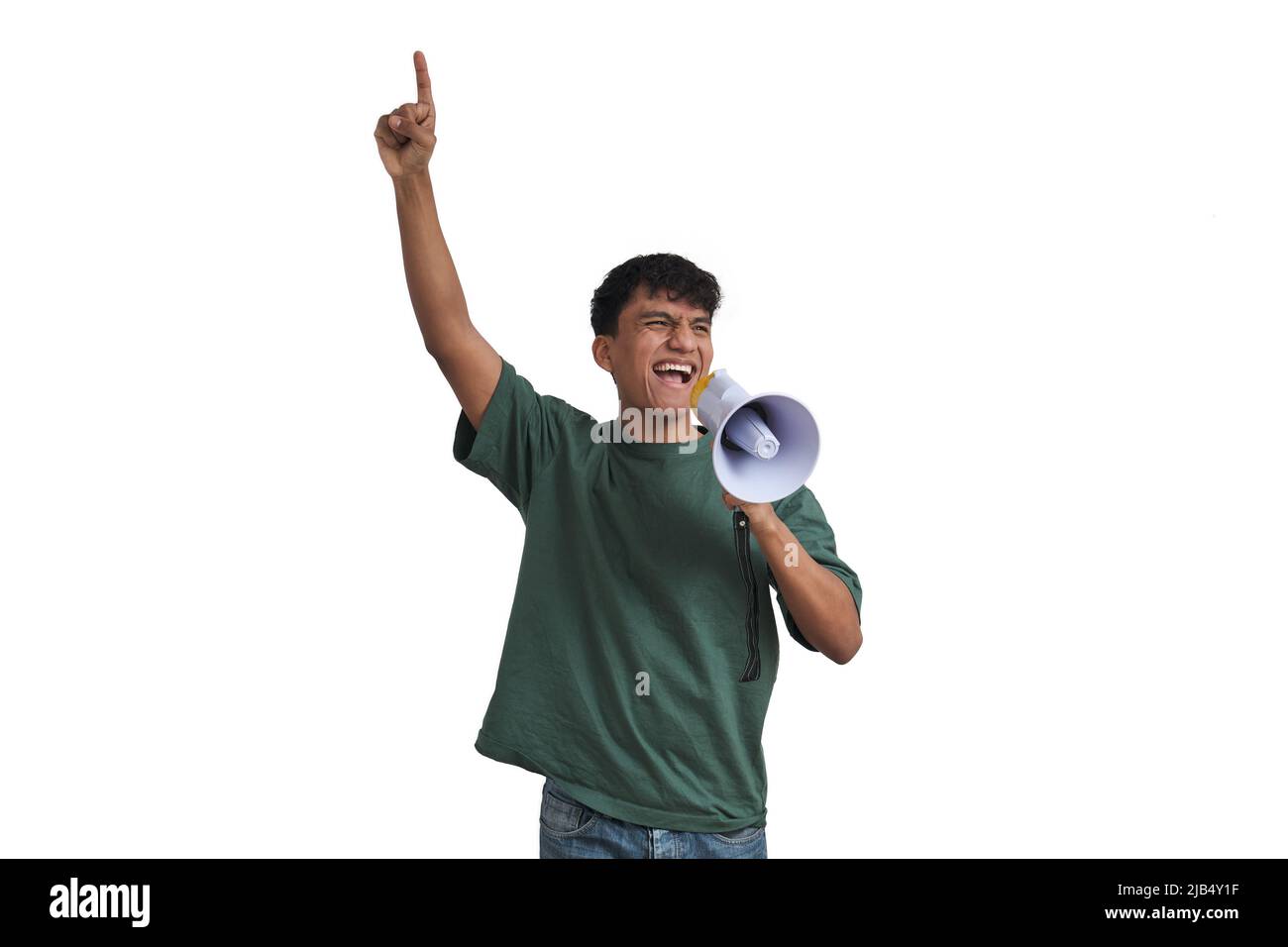 Young peruvian man shouting through megaphone and pointing up, isolated. Stock Photo