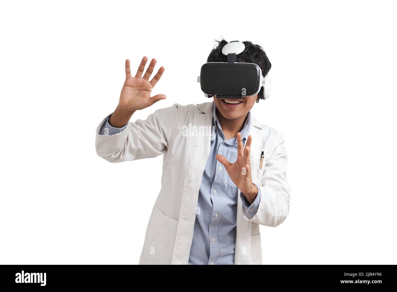 Young peruvian male scientific using virtual reality headset, isolated. Stock Photo
