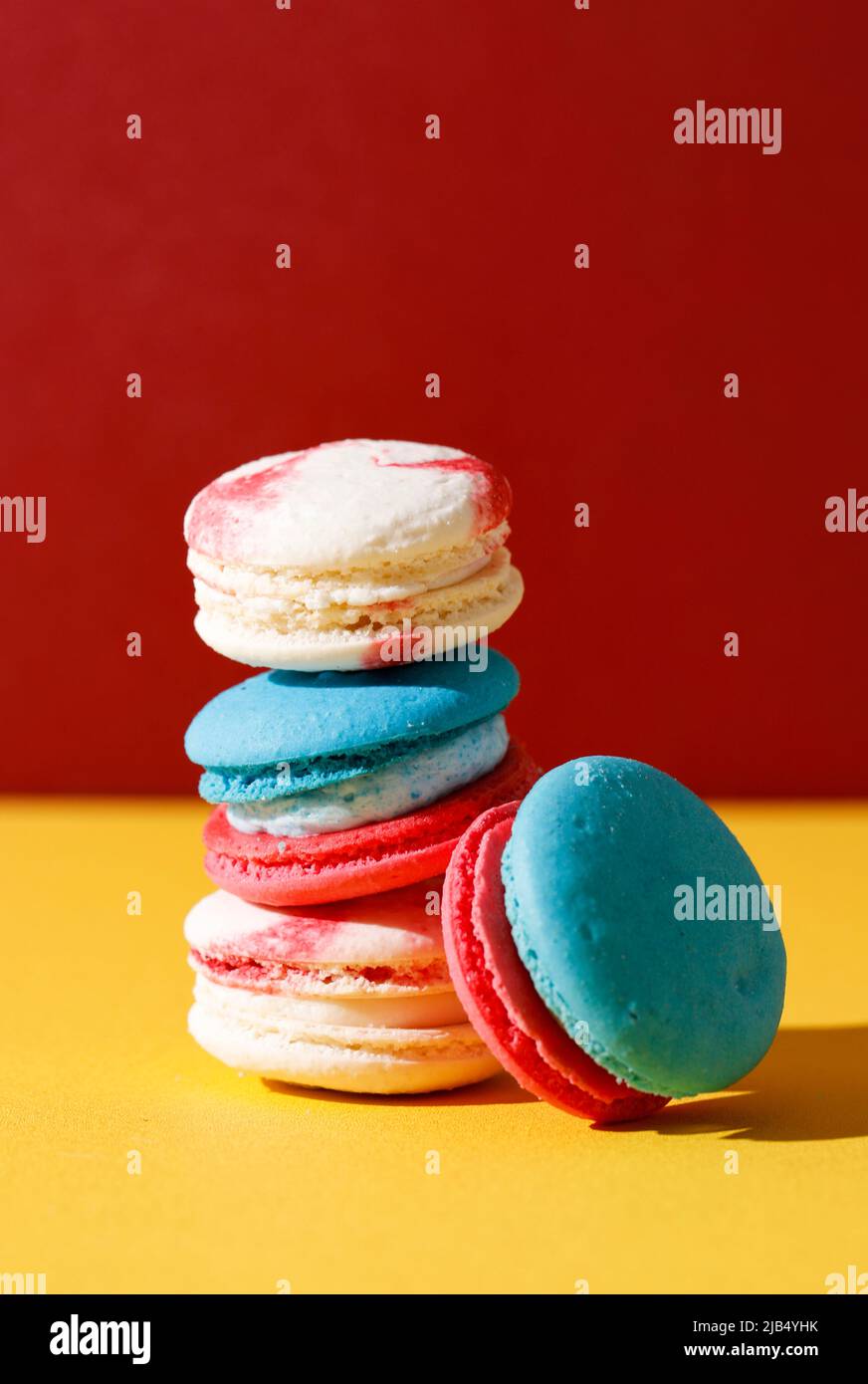 Colorful Macaroon, Stacked on Yellow and Red Background. Balanced Food