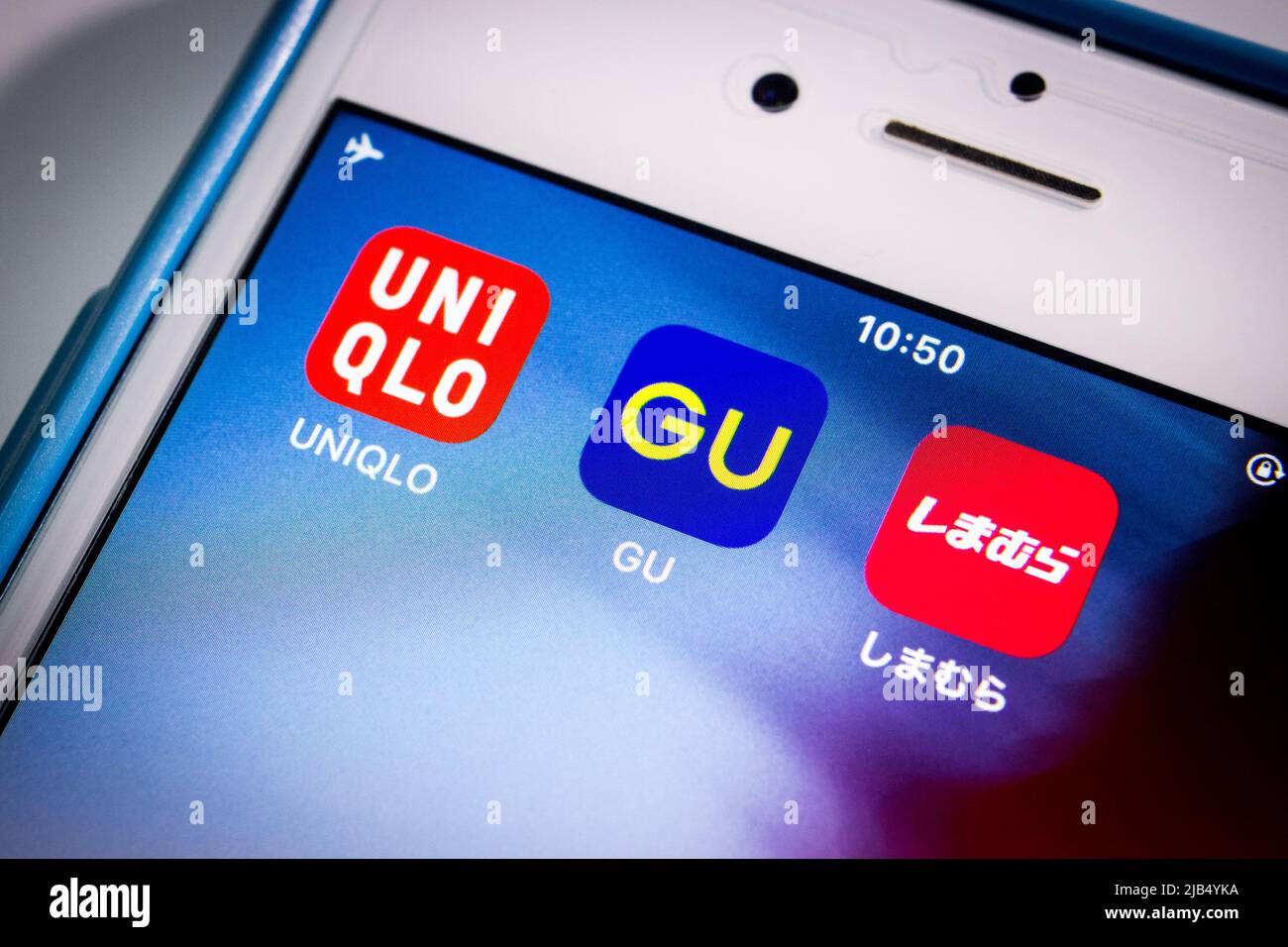 Kumamoto, Japan - Apr 29 2020 : Brand logos of UNIQLO, GU and Shimamura, the top three big giants of Japanese fast fashion industry, on iPhone screen. Stock Photo