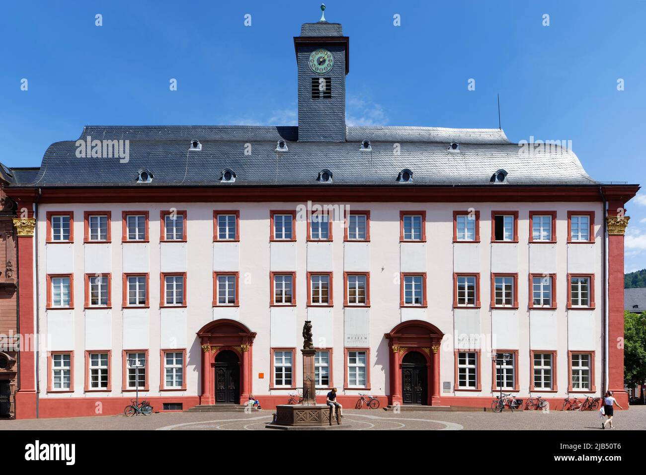 University Museum with clock tower and lion fountain, Baroque, Grabengasse, University Square, Electoral Palatinate, Heidelberg, Baden-Wuerttemberg Stock Photo
