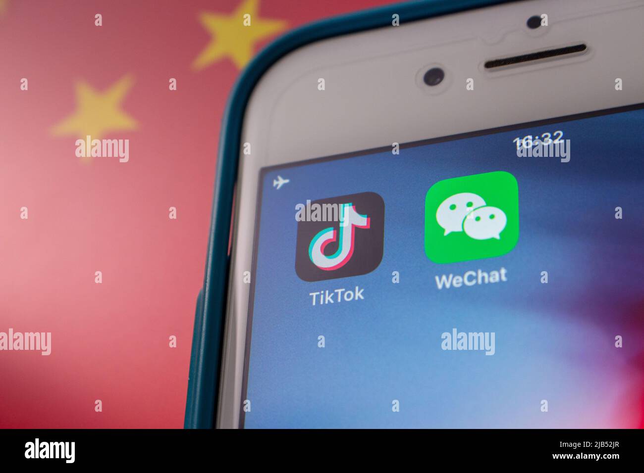 Concept image of TikTok and WeChat apps on iPhone on Chinese flag. Due to national security concerns, TikTok and WeChat are getting banned in US Stock Photo