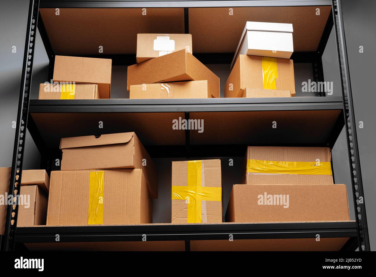Rows of shelves with cardboard boxes in modern warehouse Stock Photo ...