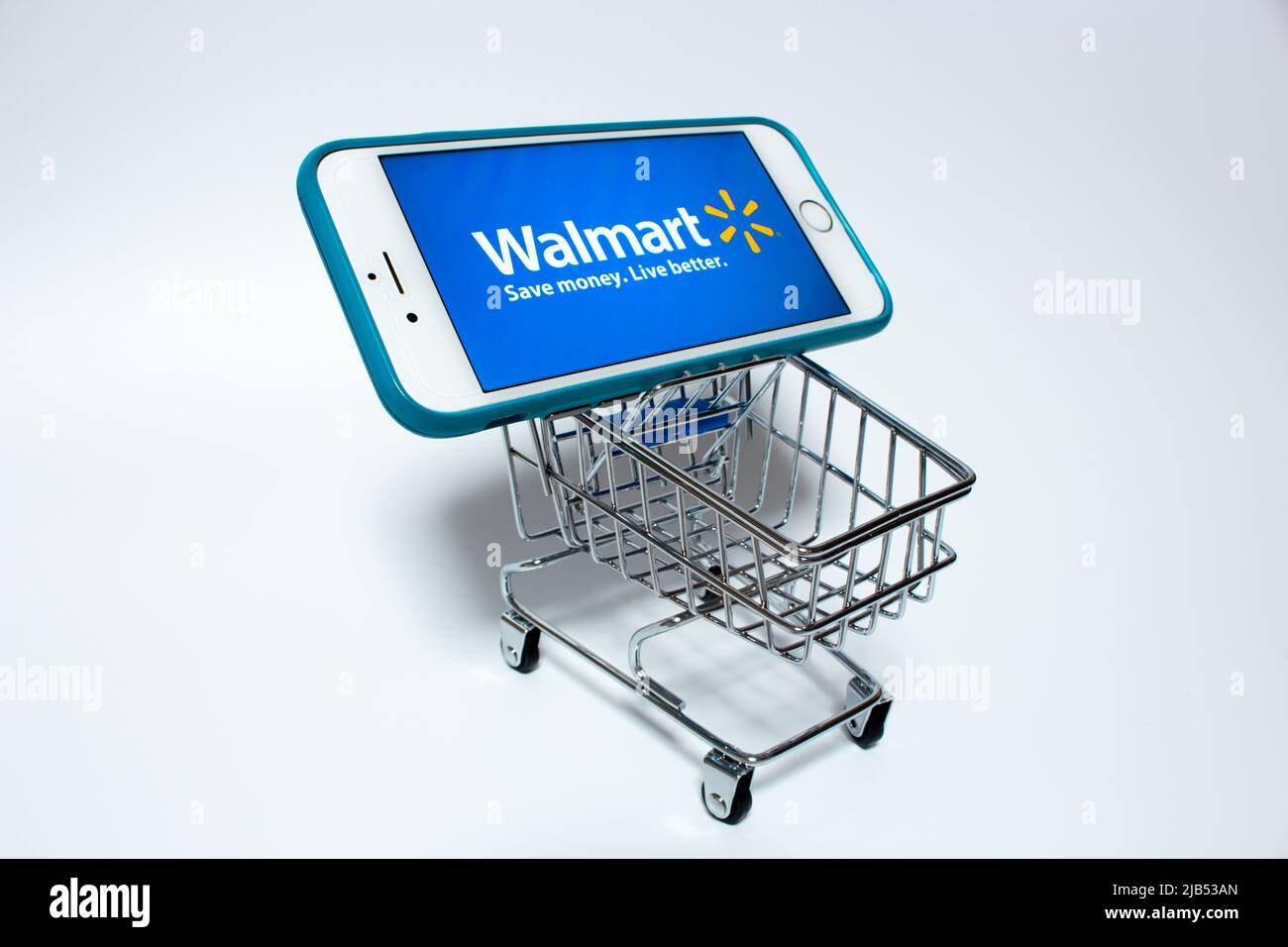 Walmart Logo on iPhone in a shopping cart. Walmart Inc. is an US retail corporation that operates a chain of hypermarkets, discount & grocery stores Stock Photo