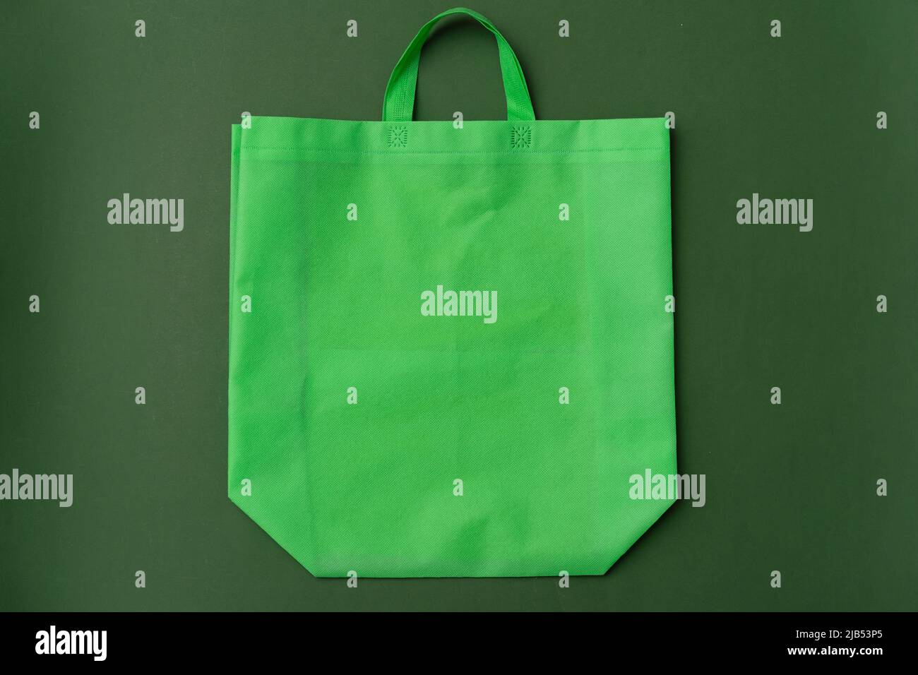 Textile shopping bag on green background flat lay Stock Photo - Alamy