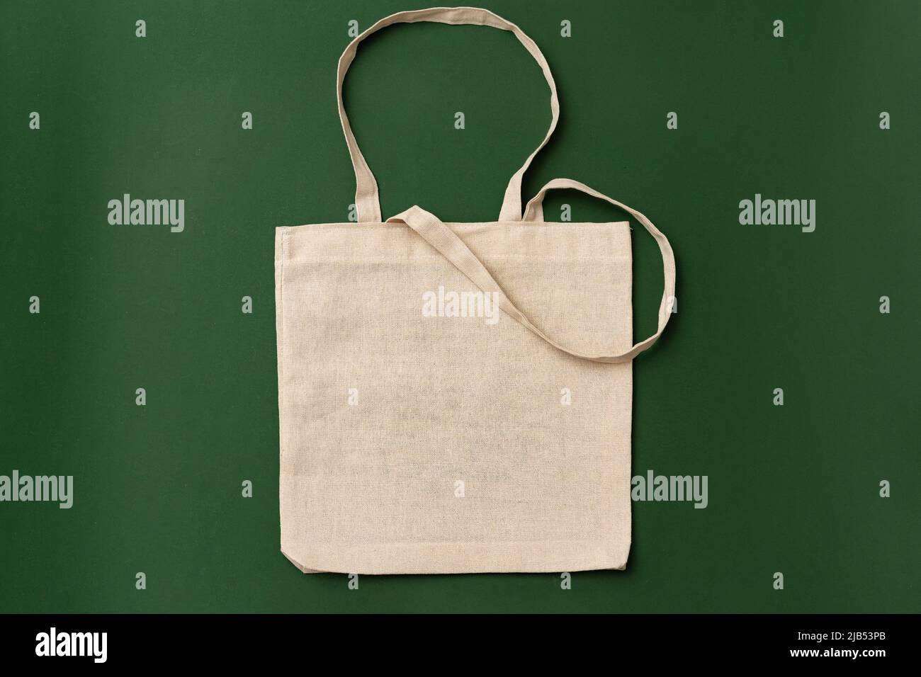 Textile shopping bag on green background flat lay Stock Photo - Alamy