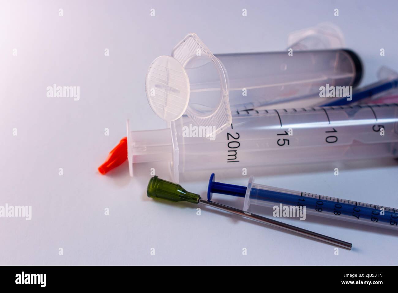 Medical syringe kit (needle, cap, syringe) on white background. Coronavirus, COVID-19, hospital and healthcare vaccine concept. Medical treatment tool Stock Photo