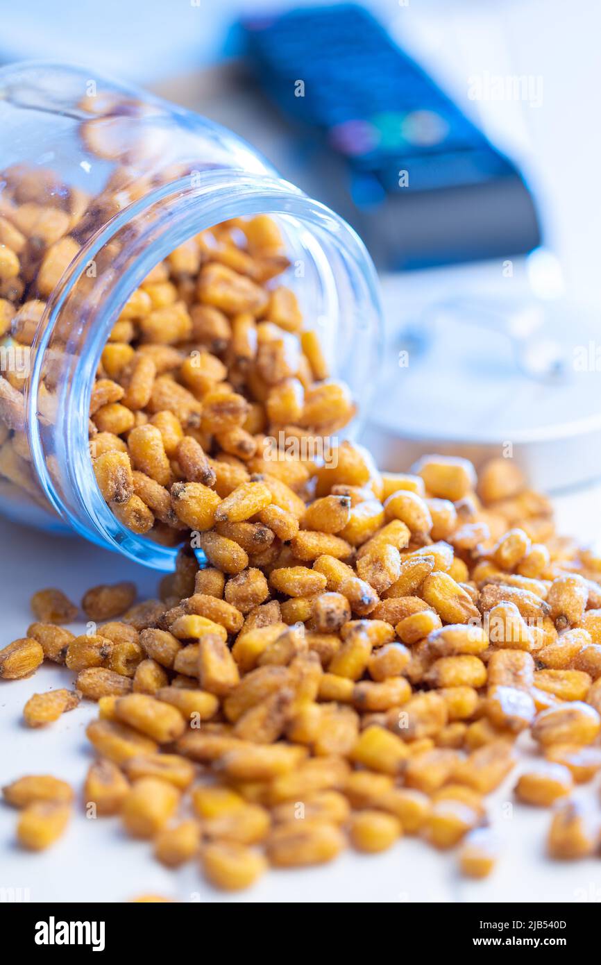 Roasted salted corn snack in jar on a white table. Stock Photo