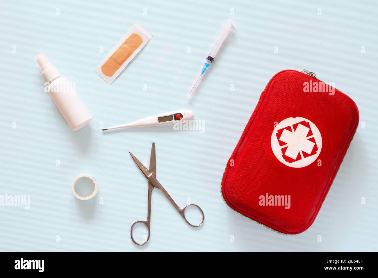 Home first aid kit, pills, thermometer on plain background Stock Photo