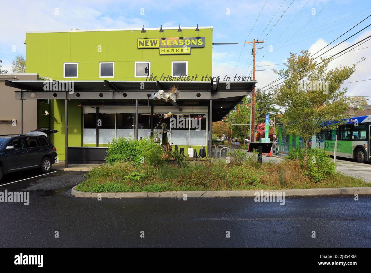 A rooftop downspout sculpture draining stormwater runoff into a bioretention area, rain garden at New Seasons Market, 1954 SE Division St,Portland, OR Stock Photo