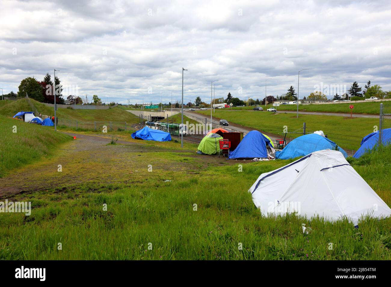 A homeless encampment along I-205 Multi-Use Path bicycle and pedestrian greenway at SE Division St, Portland, Oregon. May 3, 2022. Stock Photo