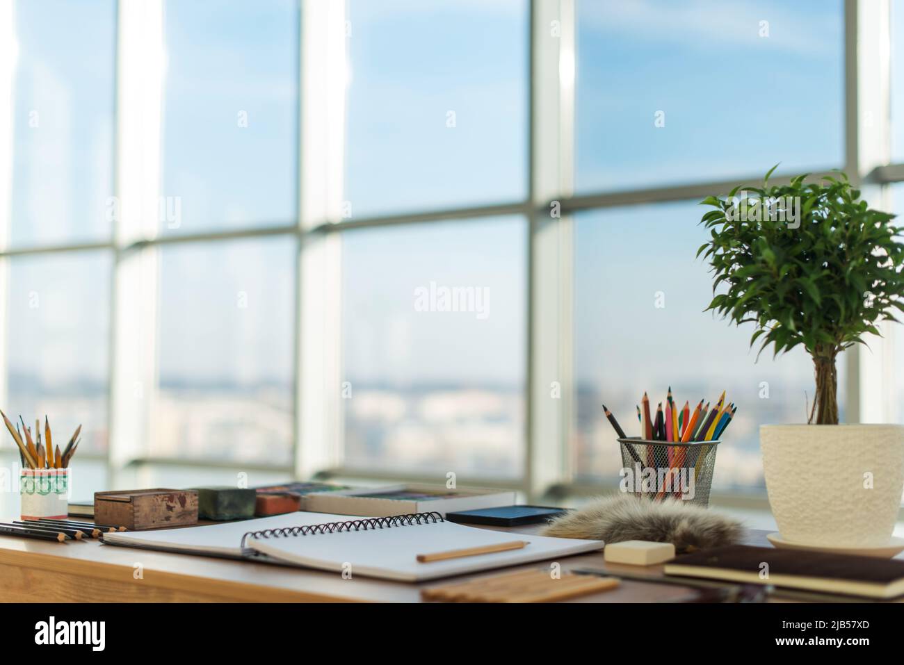 Side view of a painter workspace. Wooden desk with artistic tools ...