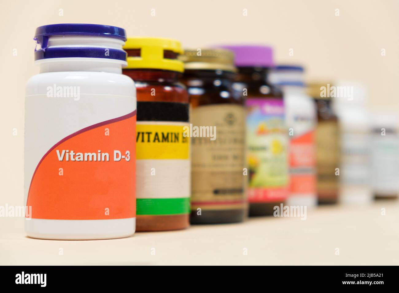 Vitamin D3 and other vitamins on a beige background. Dietary