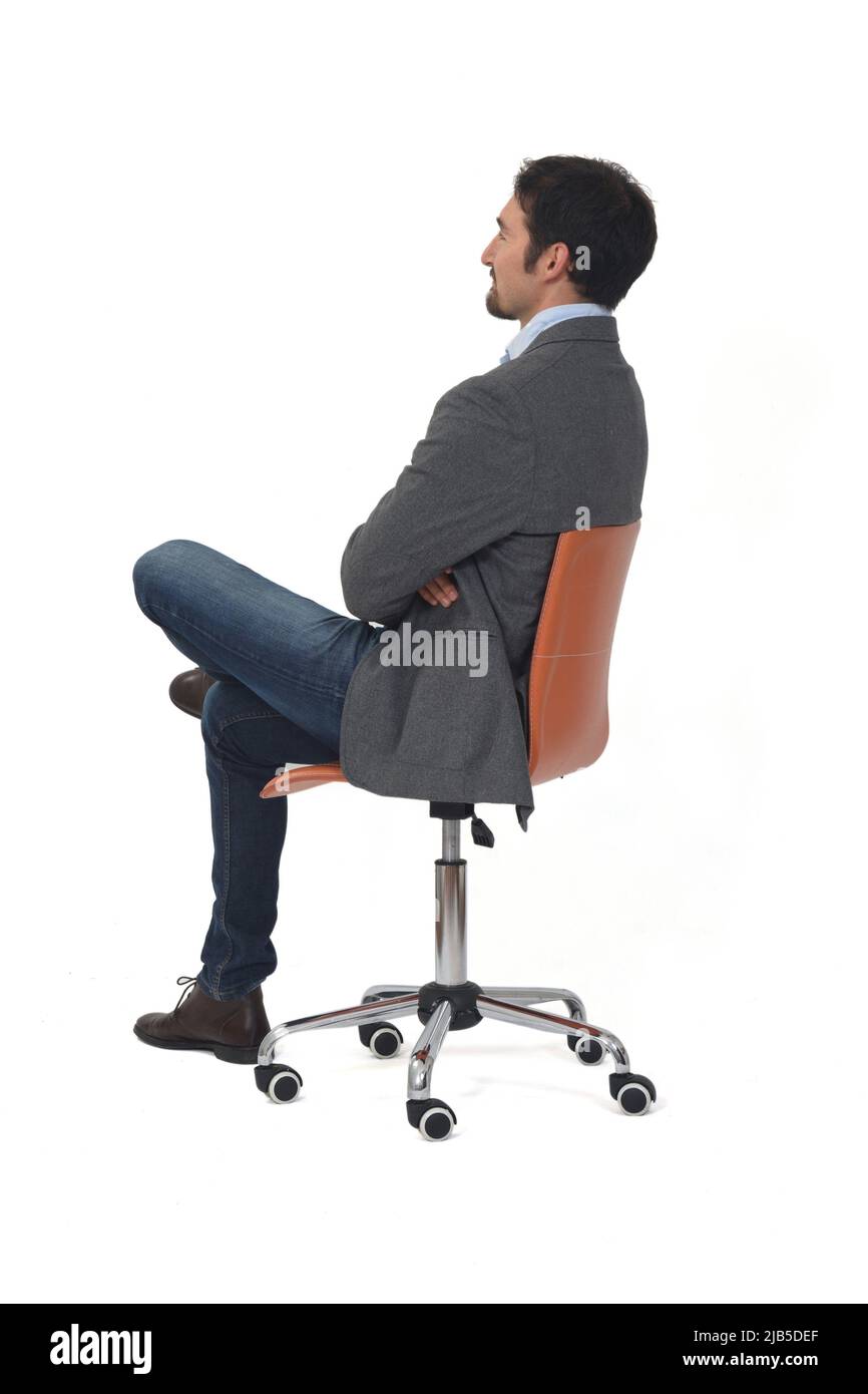 rear view of a man with blazer sitting on chair arms and legs crossed ...