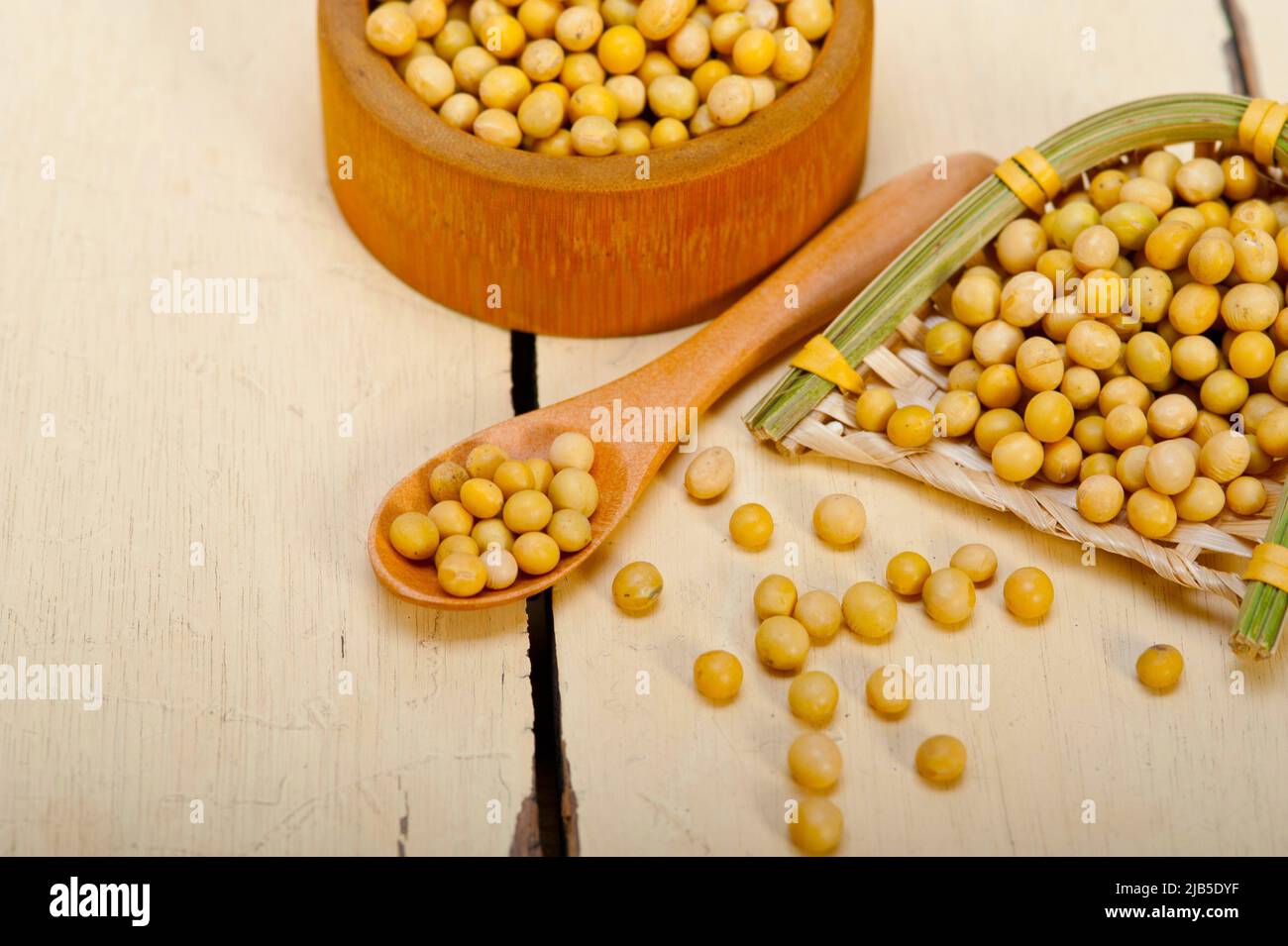 organic soya beans over rustic wood table macro closeup. Stock Photo