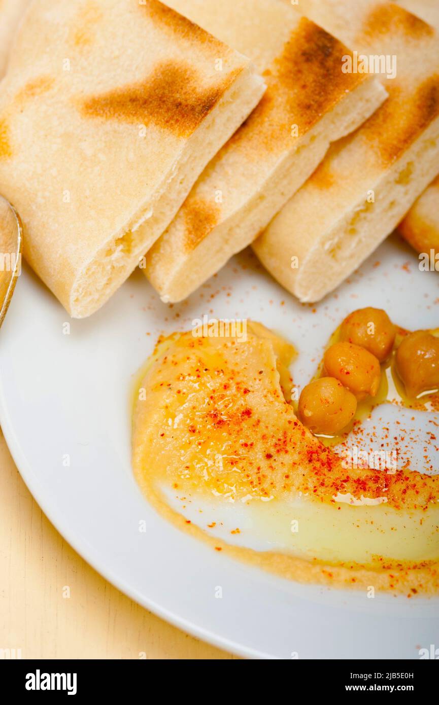 traditional chickpeas Hummus with pita bread and paprika on top. Stock Photo