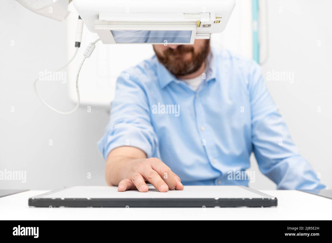 Man in x-ray room having medical scan examination in a modern hospital. High quality photo. Stock Photo