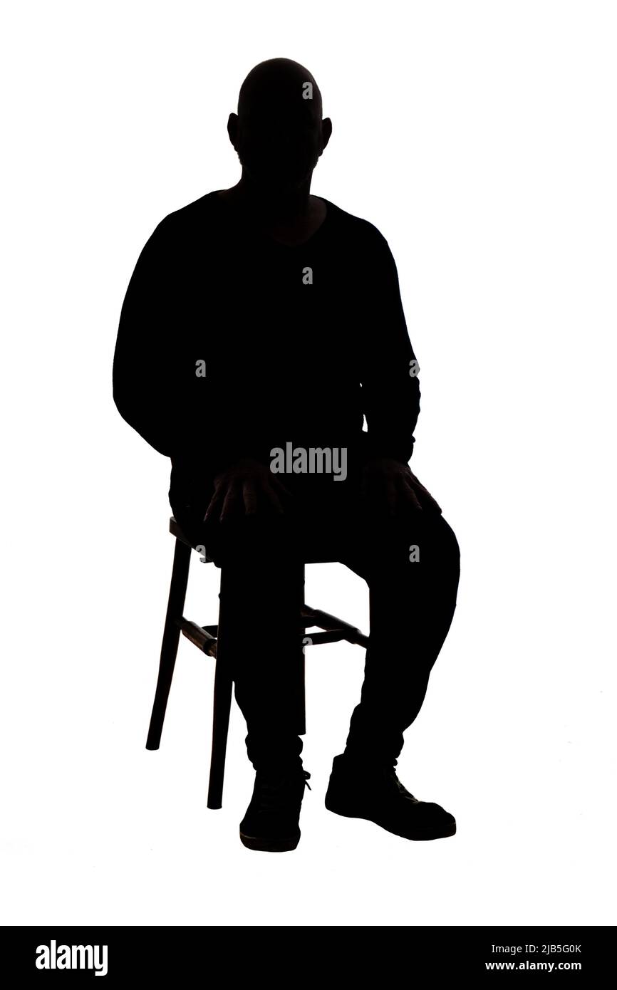 front view of the silhouette of a man sitting on chair with casual clothes Stock Photo Alamy