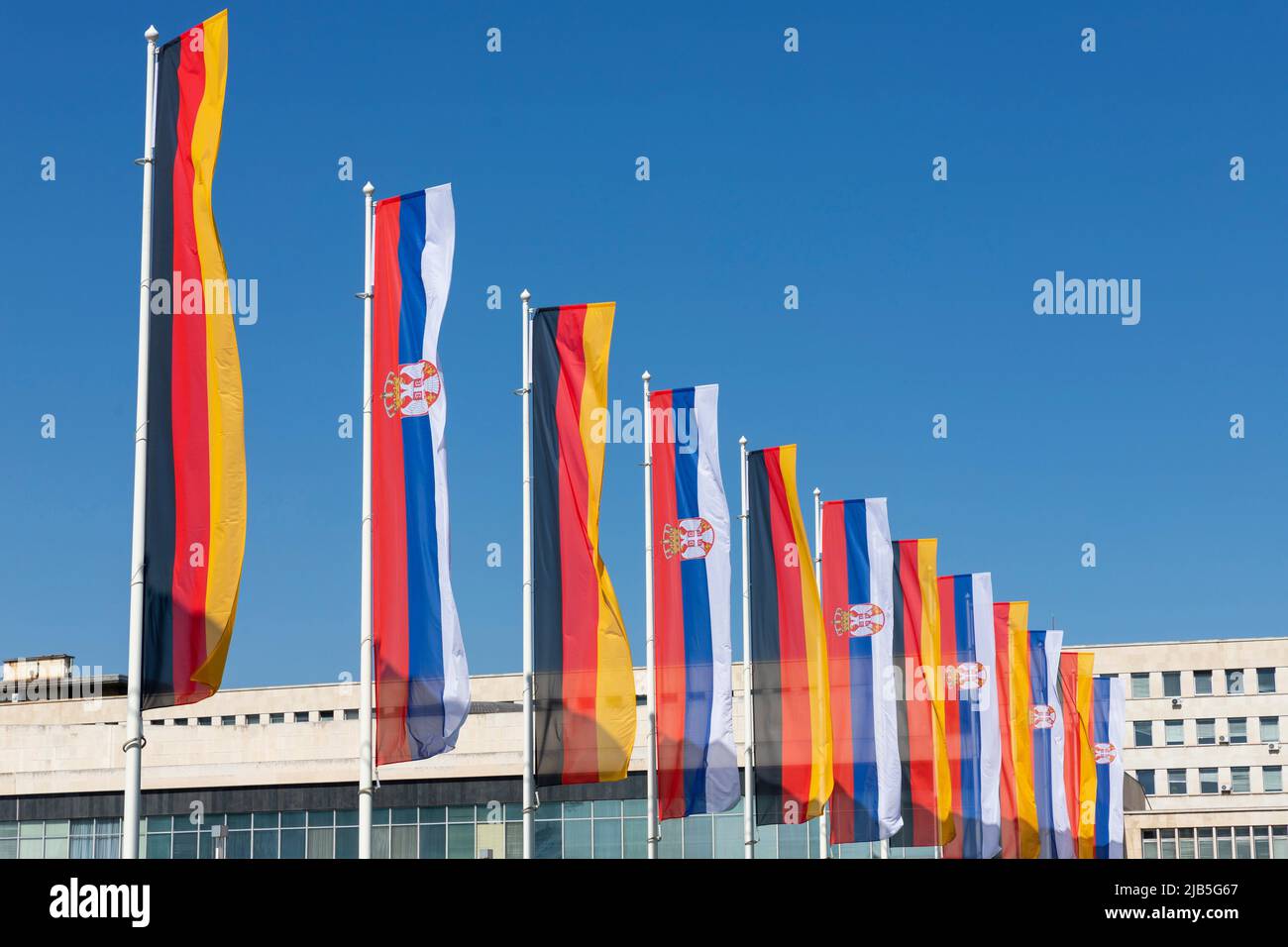 German and Serbian flags. Government, politics, diplomacy, trade, foreign relations between european countries. Stock Photo