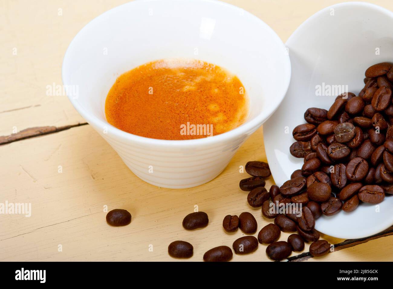 italian espresso cofee and beans on a white wood table. Stock Photo