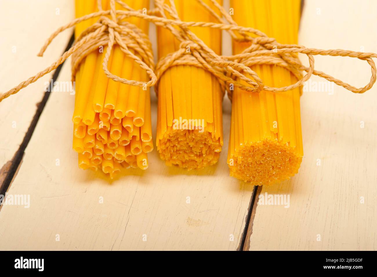 bunch of Italian pasta type on a white rustic table. Stock Photo