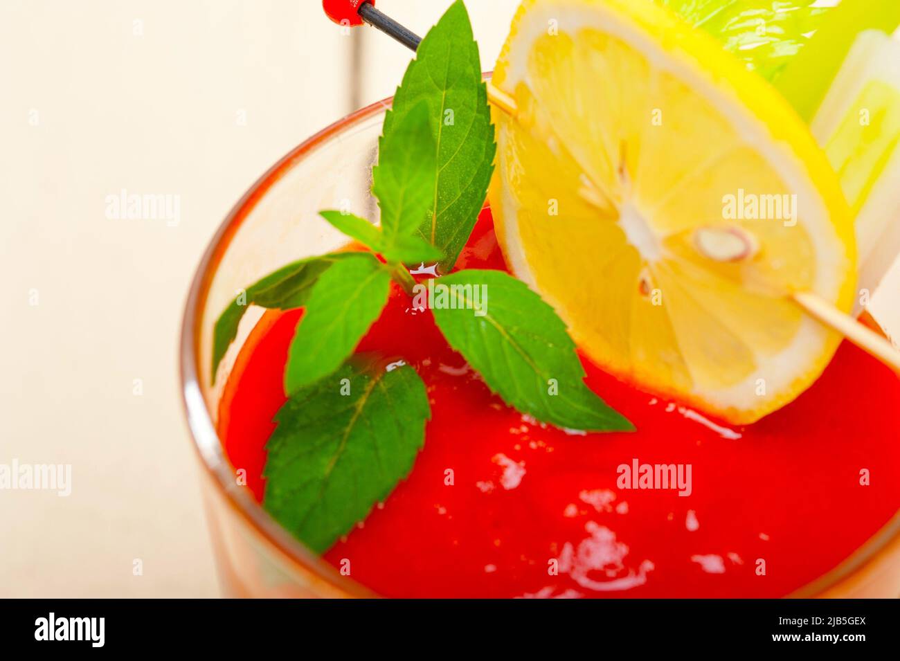 fresh tomato juice gazpacho soup on a glass over white wood table Stock