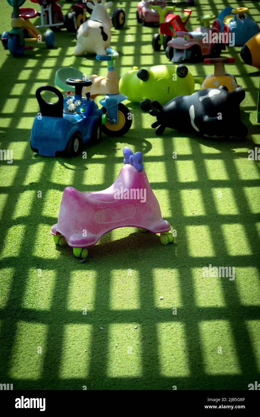 Plastic vehicle toys on green lawn Stock Photo