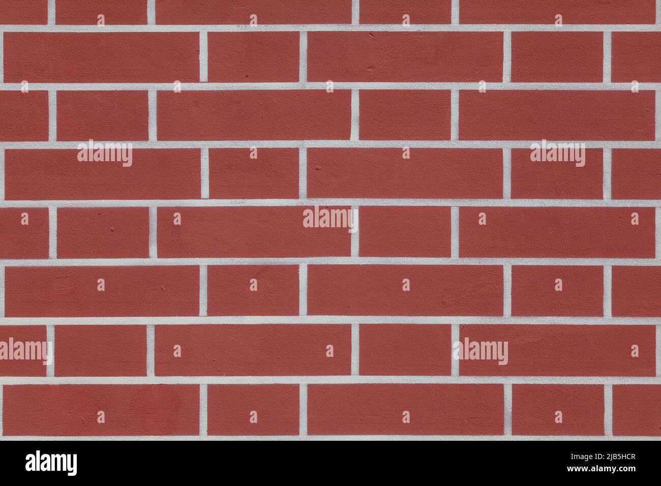 Texture - plastered red wall with painted bricks. Stock Photo