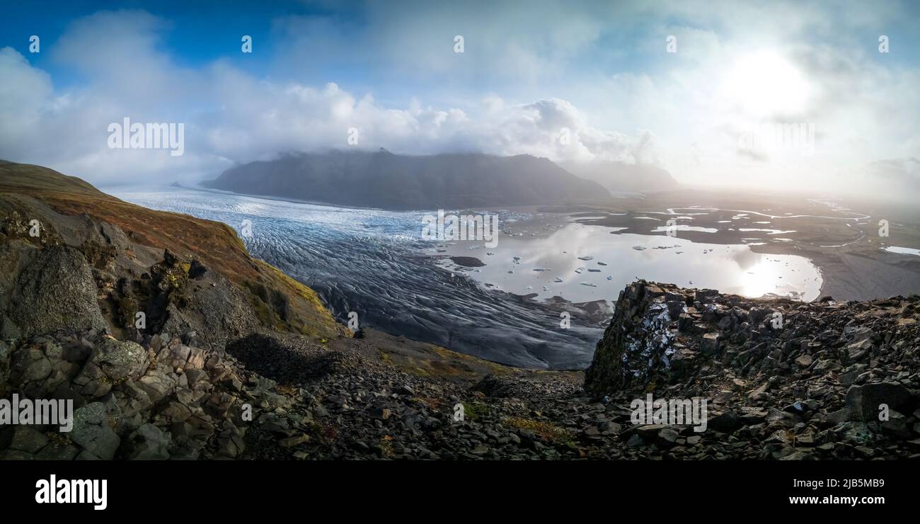 Spectacular panorama to massive glacier with clouds and ray lights Stock Photo
