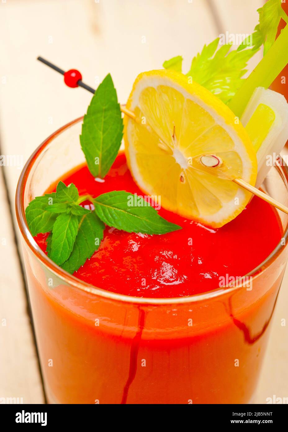 fresh tomato juice gazpacho soup on a glass over white wood table. Stock Photo