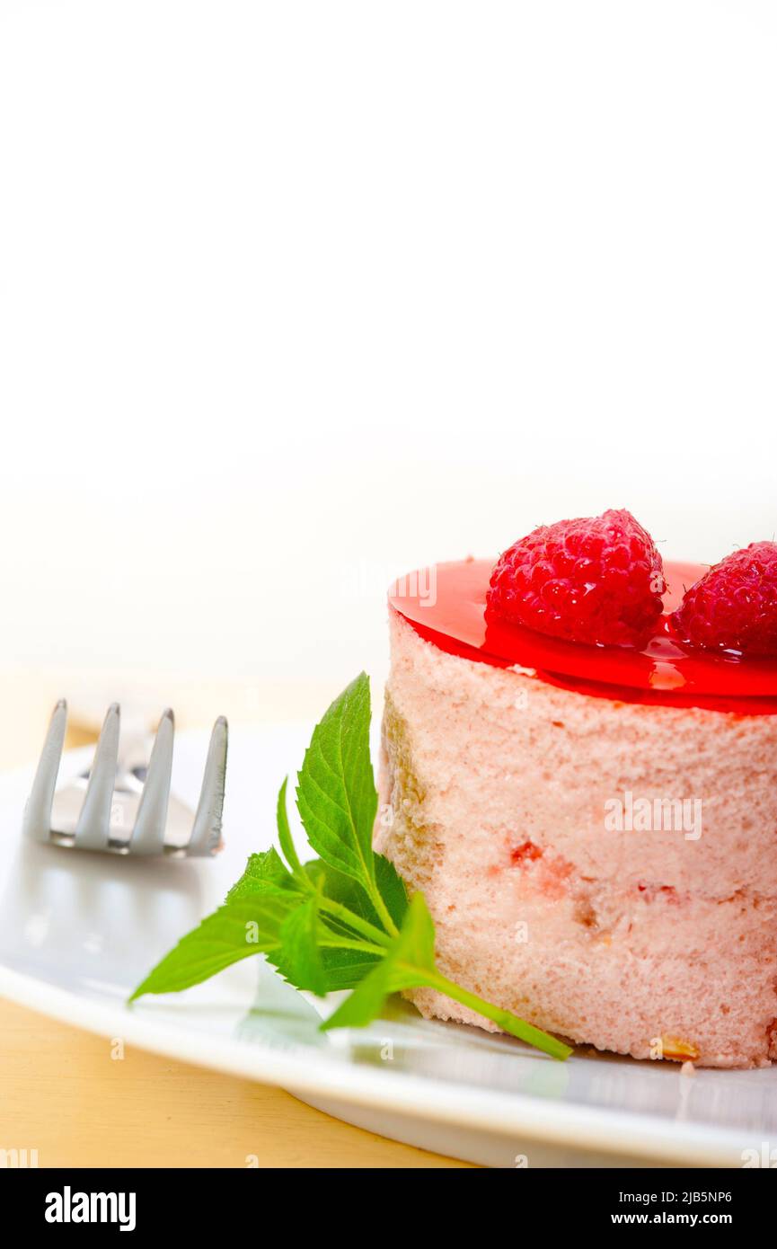fresh raspberry cake mousse dessert round shape with mint leaves. Stock Photo