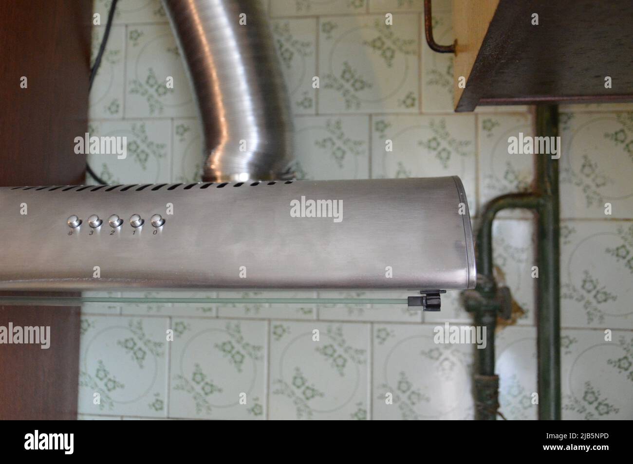 Installing a kitchen hood for the ventilation Stock Photo Alamy