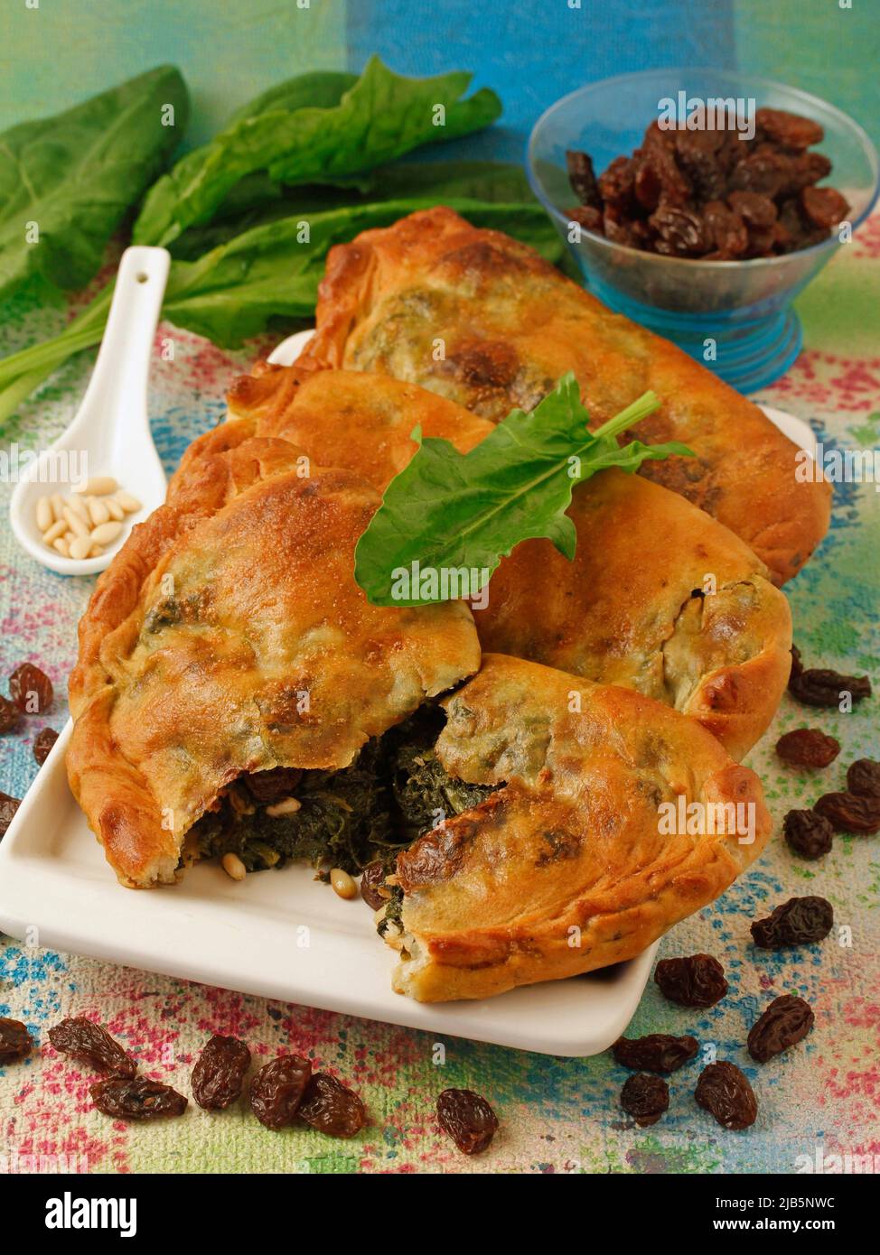 Spinach empanadas. With raisins and pine nuts. Typical from Catalonia, Spain. Stock Photo