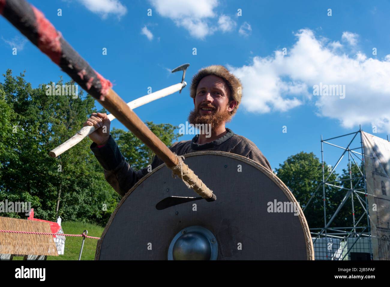 PRODUCTION - 02 June 2022, Saxony-Anhalt, Magdeburg: Philipp Rücker holds a West Slavic bar axe at the medieval festival Spectaculum Magdeburgense in Glacis Park. After the opening of the festival 'Spectaculum Magdeburgense' and the Magdeburg Fortress Days on Thursday, performances by fire artists, acrobats, craftsmen and merchants in a historical ambience are on the program until Whit Monday. In areas specially designed for the festivities, visitors will travel back in time - from the Middle Ages to the imperial era. The venues are the Glacis Park and the fortress complex 'Ravelin 2'.t. Photo Stock Photo