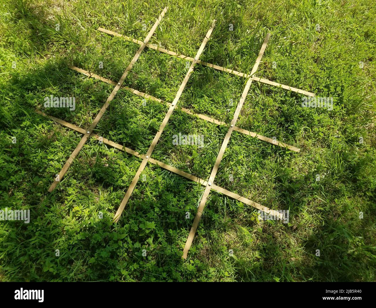 wood grid with many squares on green grass Stock Photo Alamy