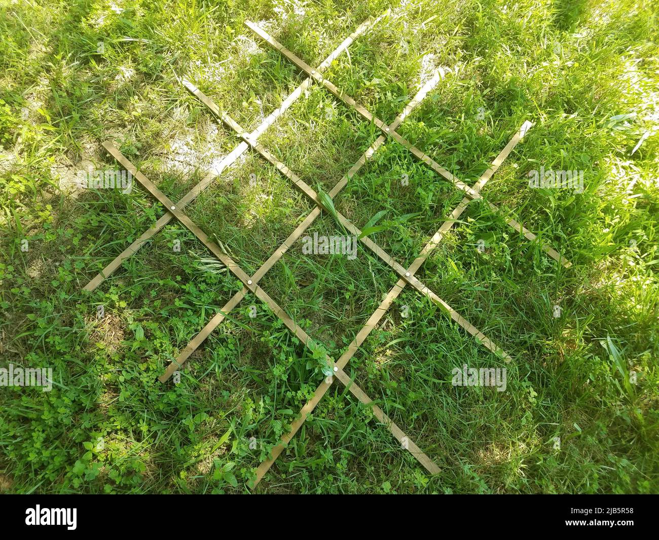 wood grid with many squares on green grass Stock Photo Alamy