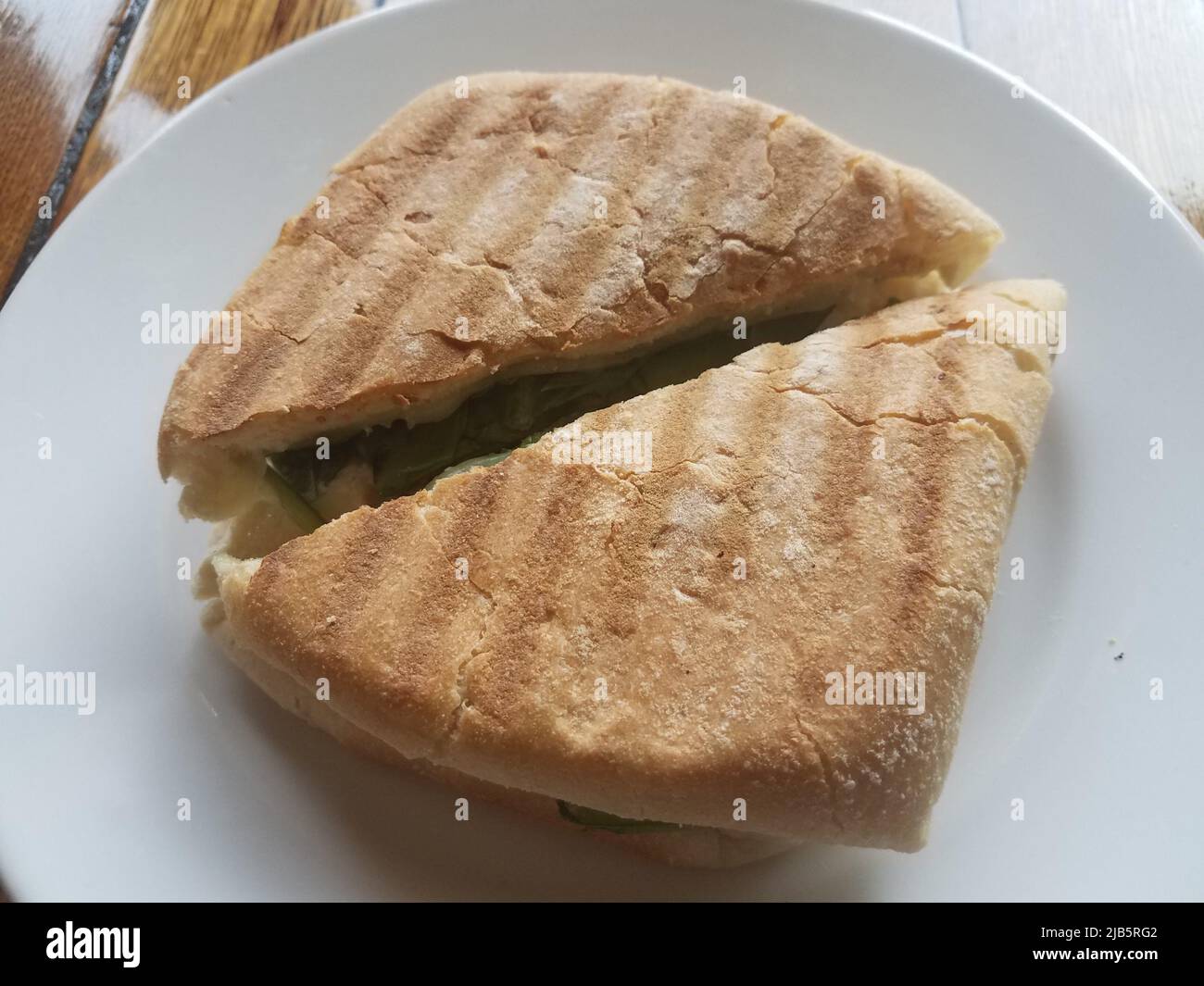 grilled sandwich bread on a while plate on a wood table Stock Photo Alamy