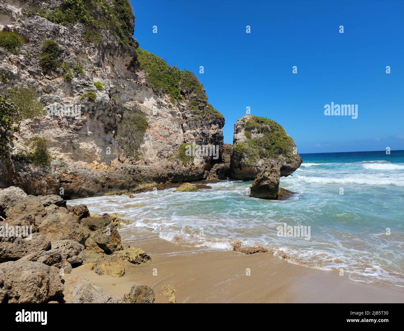rocks and beach sand and ocean near the Guajataca tunnel in Puerto Rico