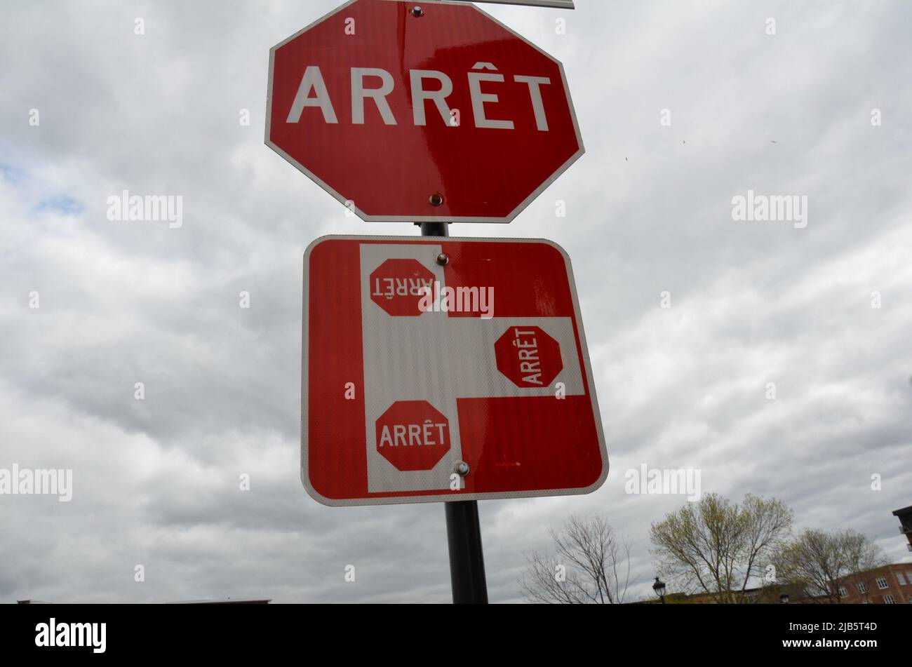 red three way stop or arret sign in Canada Stock Photo Alamy