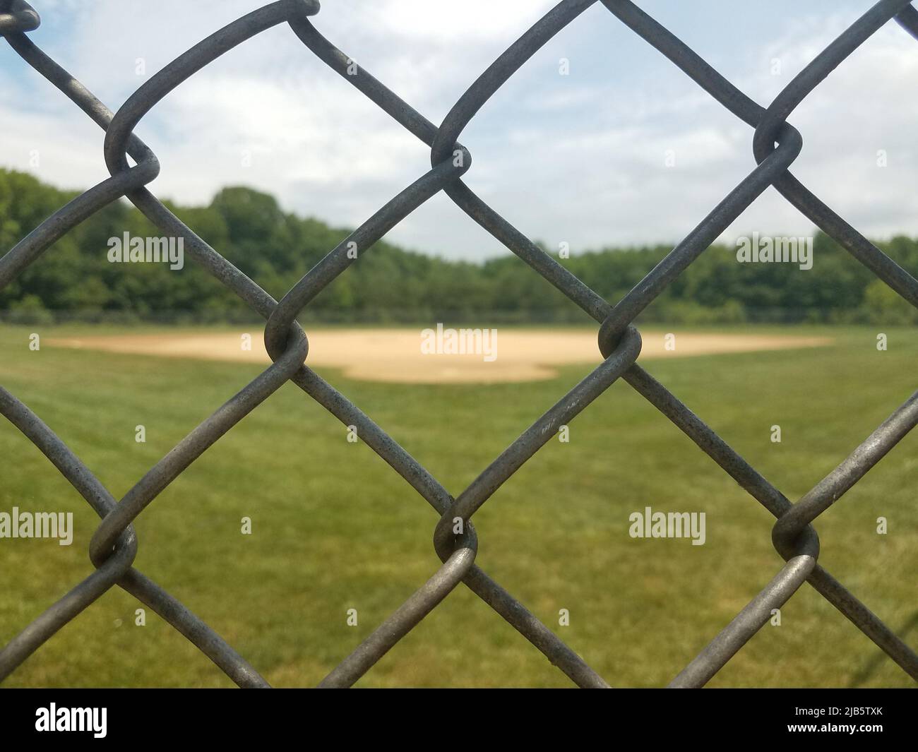 baseball diamond viewed through metal chain link fence Stock Photo Alamy