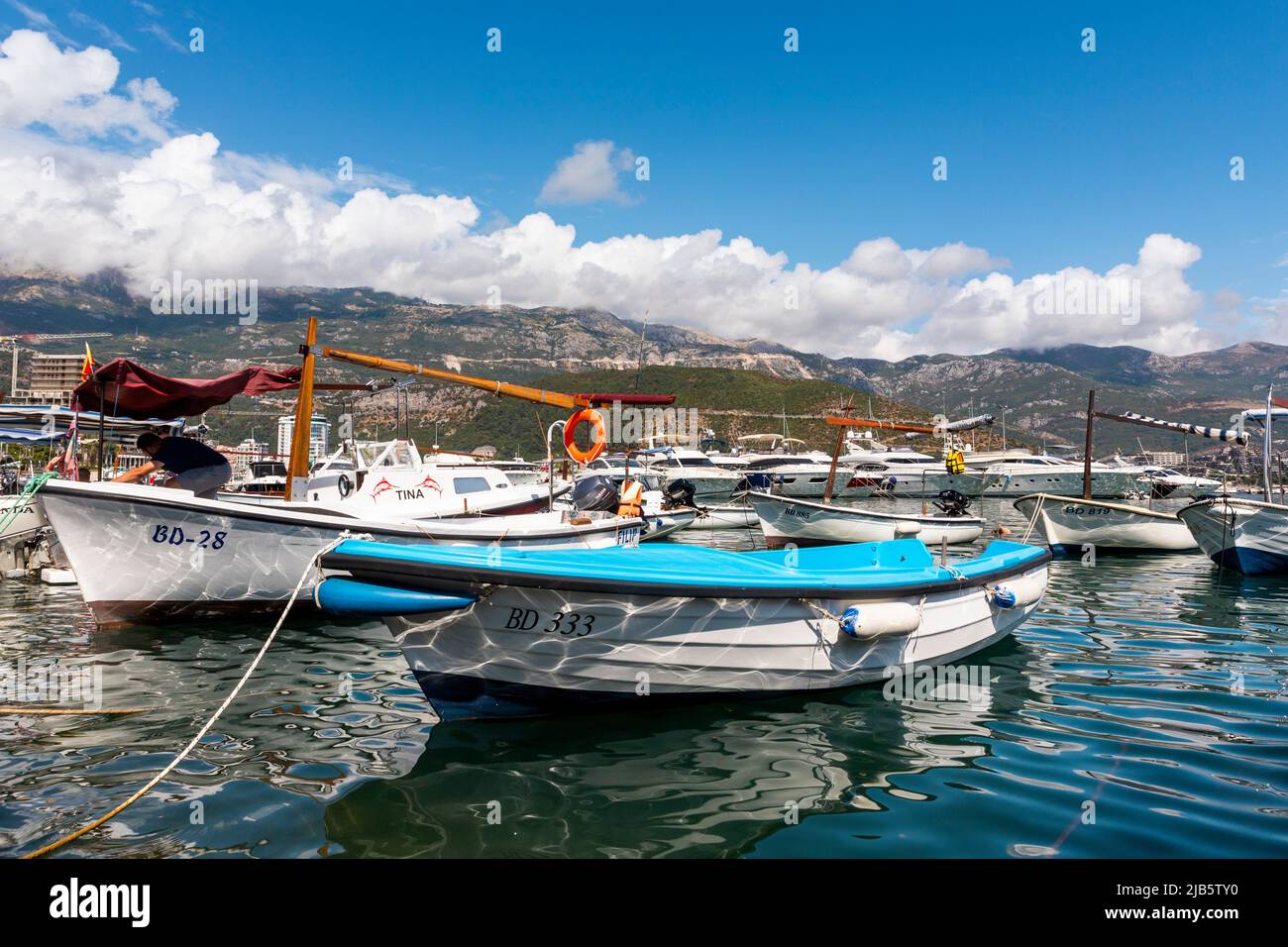 Budva, Montenegro: Boats and yachts anchored at harbour in the town of Budva, Montenegro. Luxury travel destination with beatuiful beaches at Stock Photo