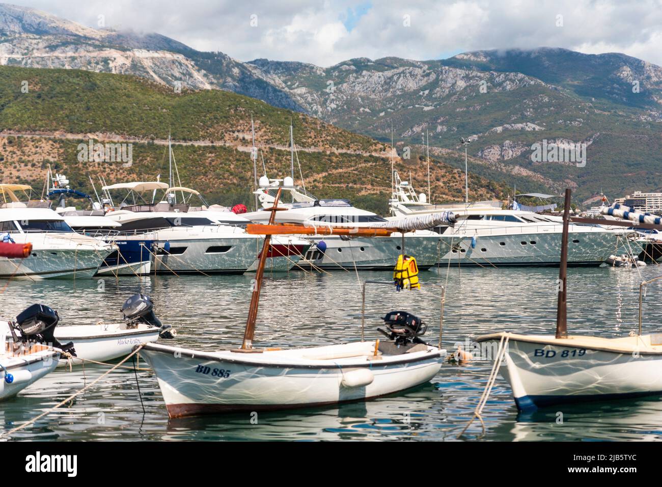 Budva, Montenegro: Boats and yachts anchored at harbour in the town of Budva, Montenegro. Luxury travel destination with beatuiful beaches at Stock Photo
