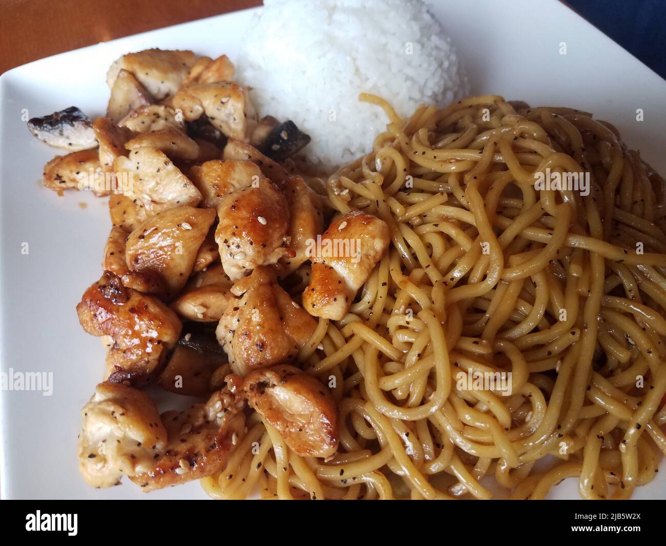 asian noodles, white rice, and seasoned chicken meat. Stock Photo