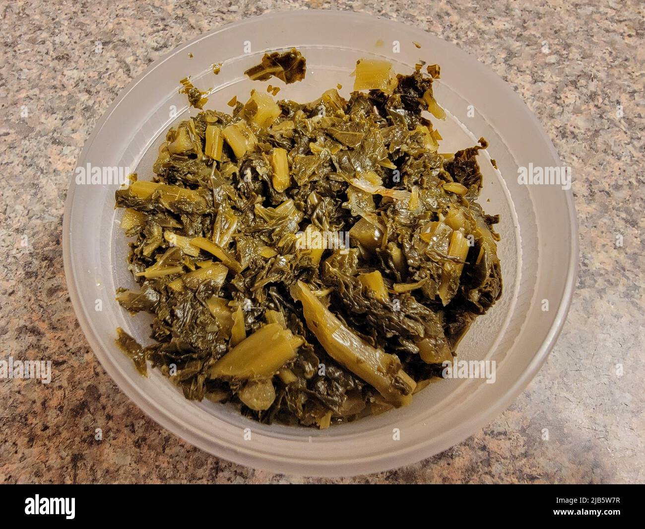 Ethiopian green cabbage or gomen in container on counter or table Stock