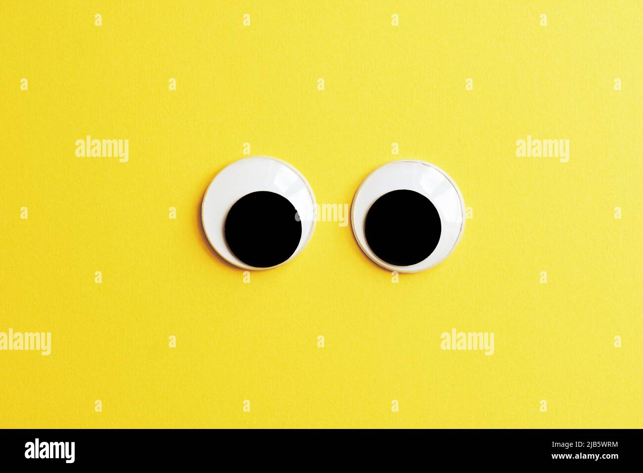 googly eyes on yellow color background Stock Photo
