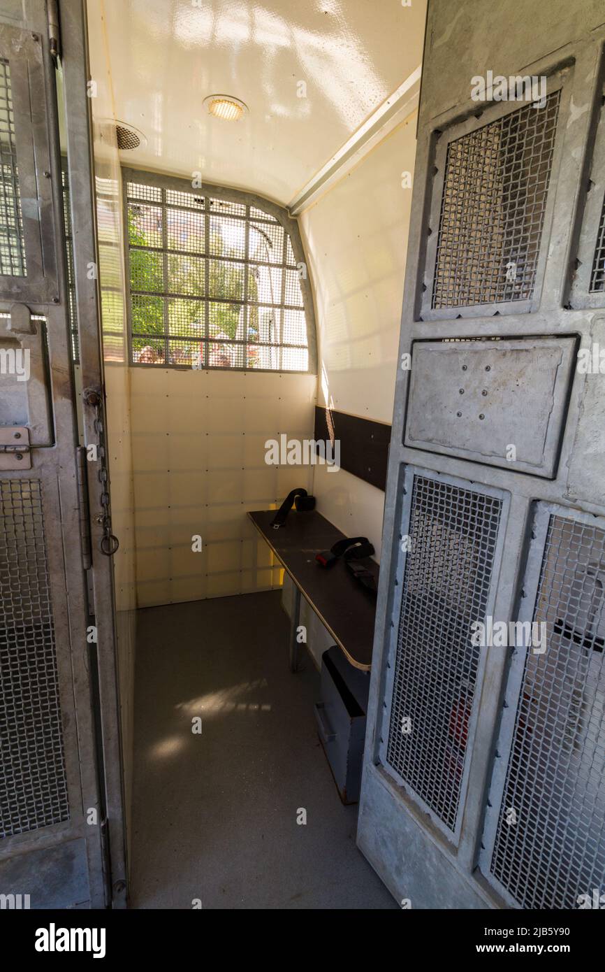 A prisoner's cell inside a paddy wagon or prisoner transport van Stock Photo